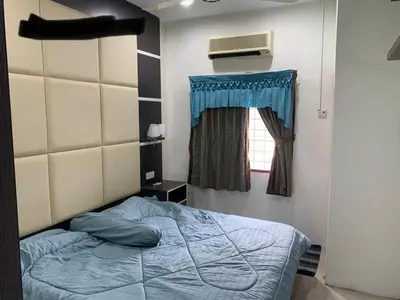 a bedroom with a bed and a window at Thind's Place in Kamunting