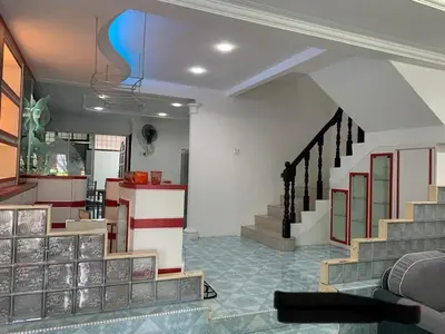 a living room with a staircase in a house at Thind's Place in Kamunting