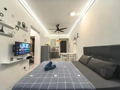 a bedroom with a bed with a blue teddy bear on it at Summer Cozy Studio Room in Perai