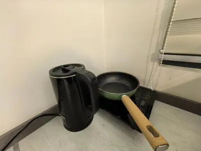 a black pot and a bowl on a counter at Summer Cozy Studio Room in Perai