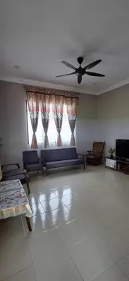 a living room with a couch and a ceiling fan at d'esaku homestay in Penaga