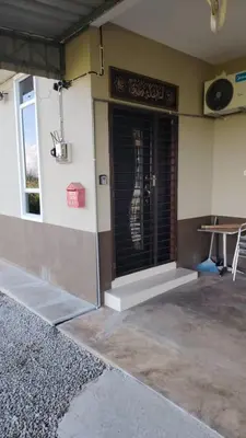 a building with a door with a guitar on it at d'esaku homestay in Penaga