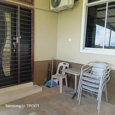 a porch with chairs and a table and a window at d'esaku homestay in Penaga