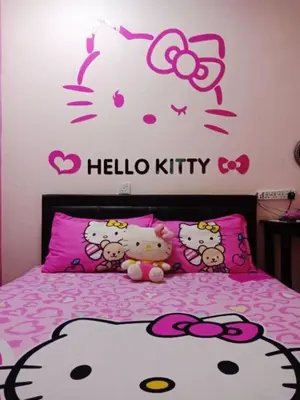 a bedroom with a hello kitty sticker on a bed at Elephant House Hotel in George Town