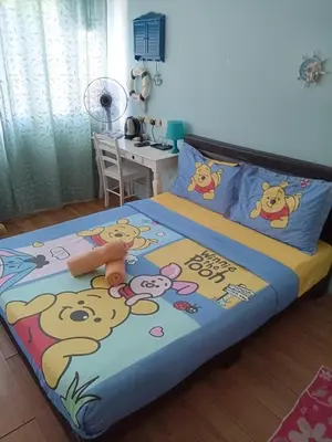 a bedroom with a bed with cartoon characters on it at Elephant House Hotel in George Town