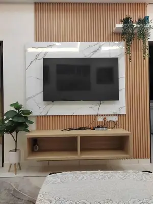 a living room with a flat screen tv on a wall at Ana Homestay in Seri Manjung