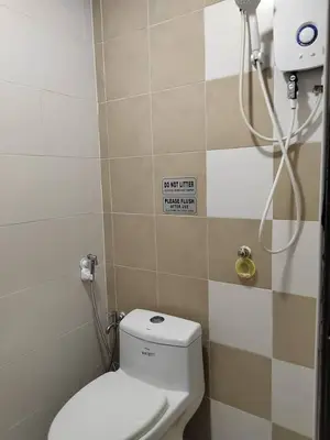 a bathroom with a toilet and a shower at Ana Homestay in Seri Manjung