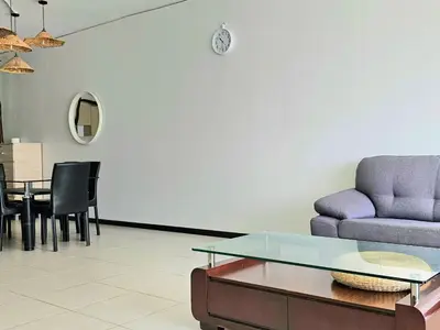 a living room with a couch and a table at Seaview and 5mins to Paddy Field and Beach in Sekincan