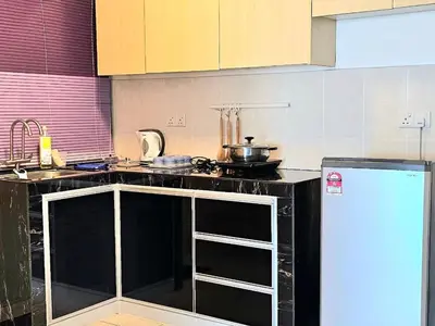 a kitchen with a stove and a counter top at Seaview and 5mins to Paddy Field and Beach in Sekincan