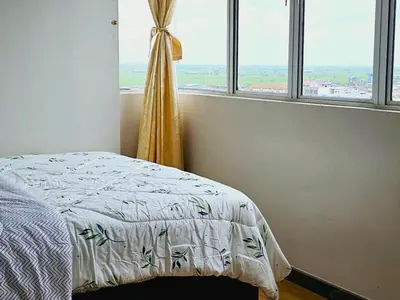 a bedroom with a bed and a window at 8\u697c\u6c11\u5bbf Enjoy the Paddy Field View in Sekincan