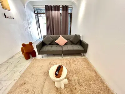 a living room with a couch and a teddy bear at CozySukun40#6pax#Netflix#NearIconCity#BukitMertajam in Bukit Mertajam