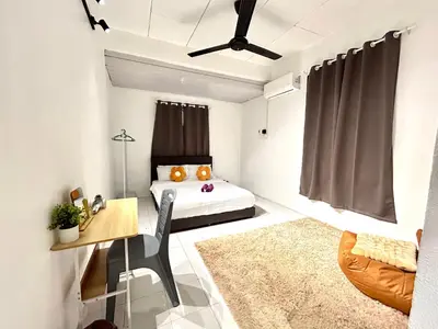 a bedroom with a bed and a table and a desk at CozySukun40#6pax#Netflix#NearIconCity#BukitMertajam in Bukit Mertajam