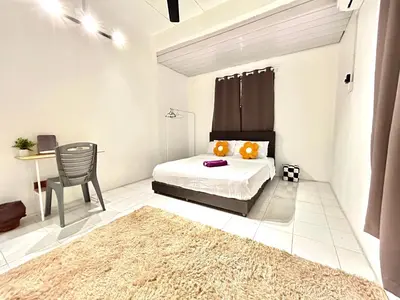 a bedroom with a bed and a table with a chair at CozySukun40#6pax#Netflix#NearIconCity#BukitMertajam in Bukit Mertajam