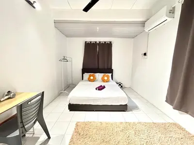 a bedroom with a bed with two pillows on it at CozySukun40#6pax#Netflix#NearIconCity#BukitMertajam in Bukit Mertajam