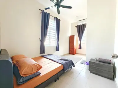 a bedroom with a bed and a ceiling fan at Premium Homestay - Tol Taiping in Kamunting