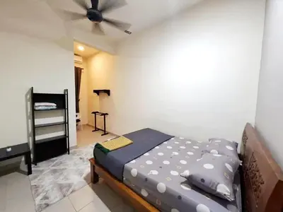 a bedroom with a bed and a ceiling fan at Premium Homestay - Tol Taiping in Kamunting
