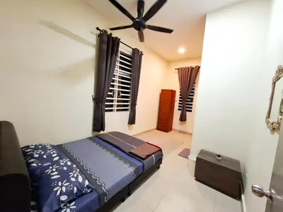 a bedroom with a bed and a ceiling fan at Premium Homestay - Tol Taiping in Kamunting