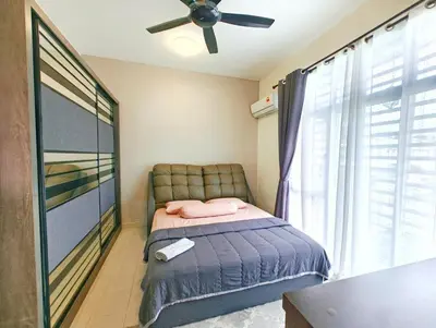 a bedroom with a bed and a ceiling fan at Premium Homestay - Tol Taiping in Kamunting