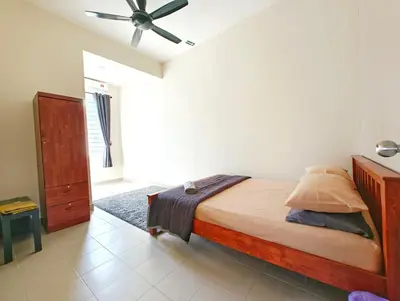 a bedroom with a bed and a ceiling fan at Premium Homestay - Tol Taiping in Kamunting