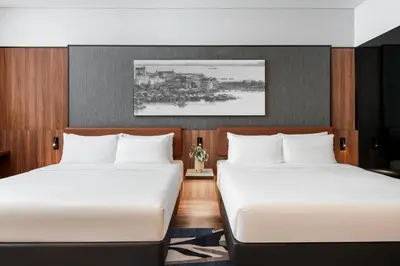 two beds sitting next to each other in a room at Citadines Connect Bertam Georgetown Penang in George Town