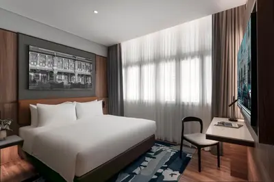a bedroom with a large white bed and a desk at Citadines Connect Bertam Georgetown Penang in George Town