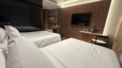 a hotel room with two beds and a flat screen tv at Citadines Connect Bertam Georgetown Penang in George Town