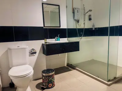 a bathroom with a shower and a toilet and a sink at Georgetown Mansion One Apartment by Jere Penang Gleneagles Gurney in George Town