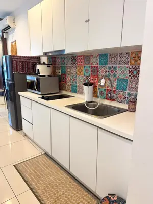 a kitchen with white cabinets and a sink at Georgetown Mansion One Apartment by Jere Penang Gleneagles Gurney in George Town