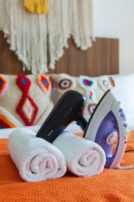 a pair of scissors sitting on top of towels at Georgetown Mansion One Apartment by Jere Penang Gleneagles Gurney in George Town