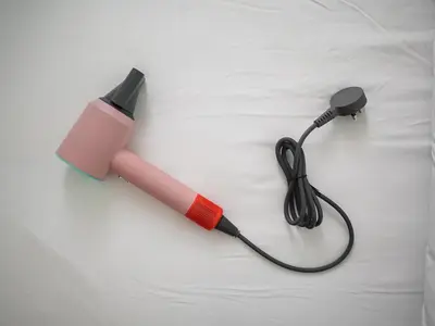 a blow dryer with a cord on a bed at Maritime Suite Haus - Penang Top Sea View in Jelutong