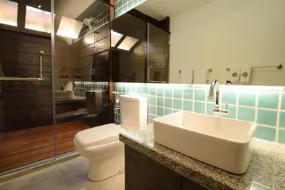 a bathroom with a sink and a toilet and a shower at Sarang Paloh Heritage Stay in Ipoh