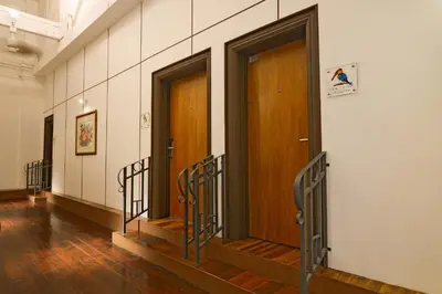 a hallway with two wooden doors in a building at Sarang Paloh Heritage Stay in Ipoh