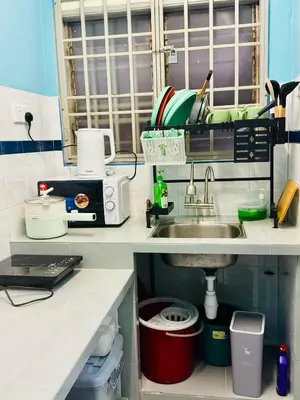 a kitchen with a sink and a counter top at Apartment in gelugor usm in Gelugor