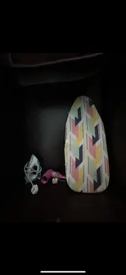 a colorful backpack sitting on a shelf with a helmet at Apartment in gelugor usm in Gelugor