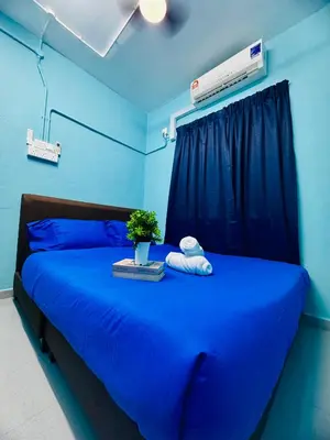 a blue bedroom with a blue bed with a blue wall at Apartment in gelugor usm in Gelugor