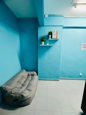 a blue room with a dog bed on a blue wall at Apartment in gelugor usm in Gelugor