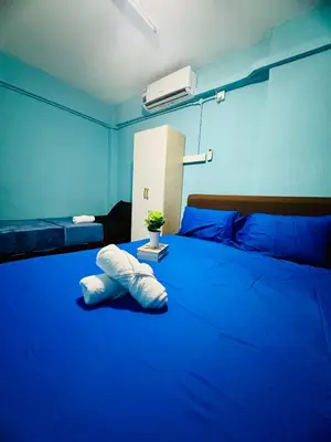 a blue room with a large bed with blue sheets at Apartment in gelugor usm in Gelugor