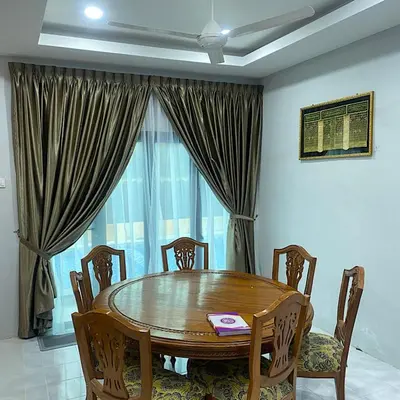 a wooden table and chairs in a room with a window at Darainhomestay in Gua Sai