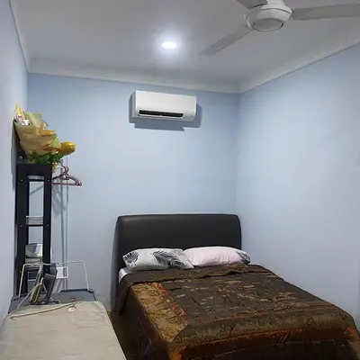 a bedroom with a bed and a air conditioner at Darainhomestay in Gua Sai