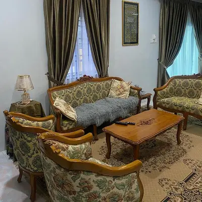 a living room with a couch and chairs and a table at Darainhomestay in Gua Sai
