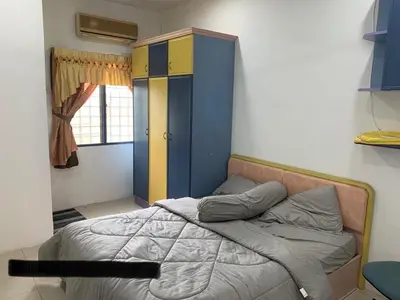 a bedroom with a bed and a blue and yellow cabinet at Thind place in Kamunting
