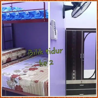 a room with a bunk bed and a door with a bed sqor at Zara's Homestay in Kuala Kurau