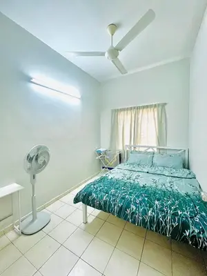 a bedroom with a bed and a fan at Teha Homestay Botani in Ipoh