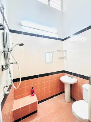 a bathroom with a shower and a toilet and a sink at Teha Homestay Botani in Ipoh