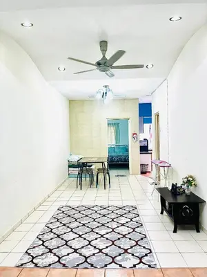 a living room with a ceiling fan and a table at Teha Homestay Botani in Ipoh