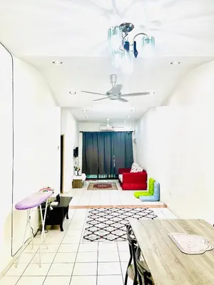 a living room with a table and a couch at Teha Homestay Botani in Ipoh