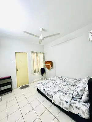 a bedroom with a bed and a ceiling fan at Teha Homestay Botani in Ipoh