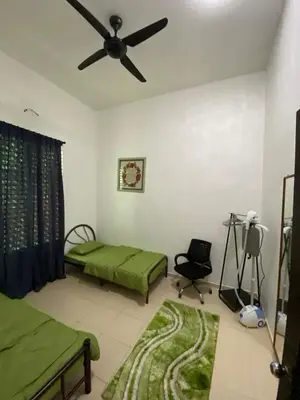a bedroom with two beds and a ceiling fan at Laman Moon Homestay, Melaka in Gua Sai