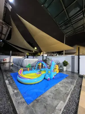 a inflatable water park on a blue carpet at Laman Moon Homestay, Melaka in Gua Sai