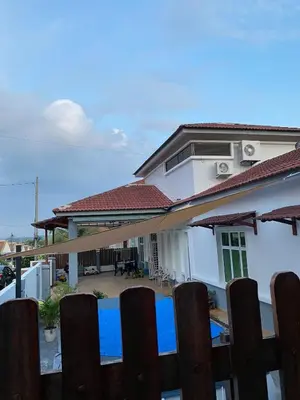 a house with a fence in front of it at Laman Moon Homestay, Melaka in Gua Sai